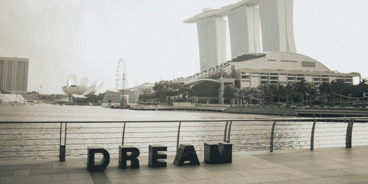 Singapore landscape with the MBS hotel in the background and a Dream logo in the foreground