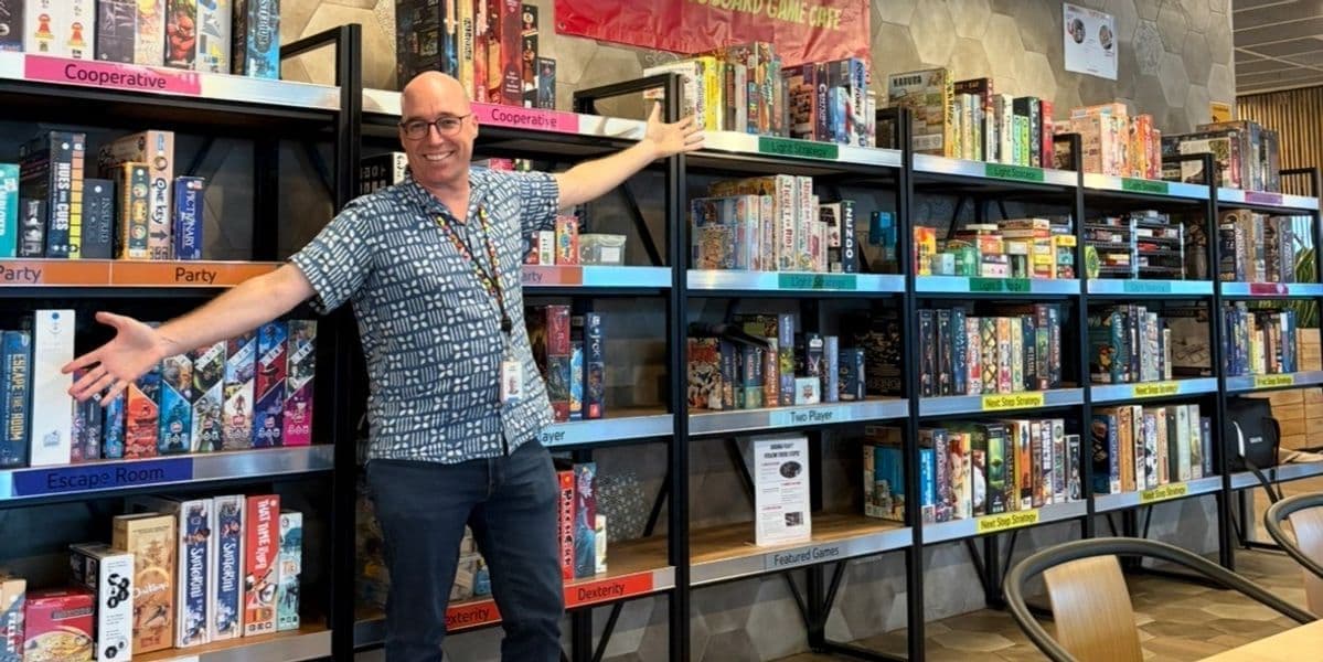 Brian in front of the board game cafe he built in Singapore