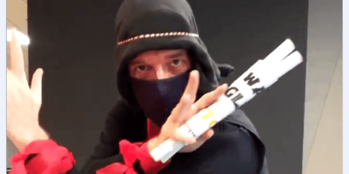 Brian dressed as a ninja in a fighting pose holding chopsticks