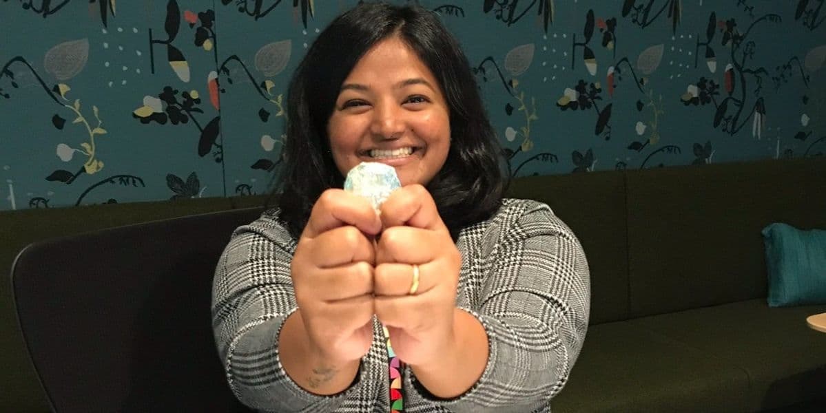 Person happily holding a gold coin