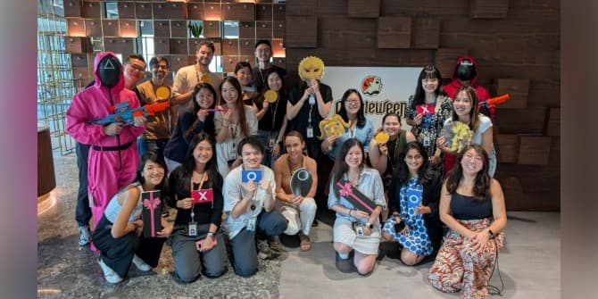 Brian and Tom dressed in Squid Game costumes with participants